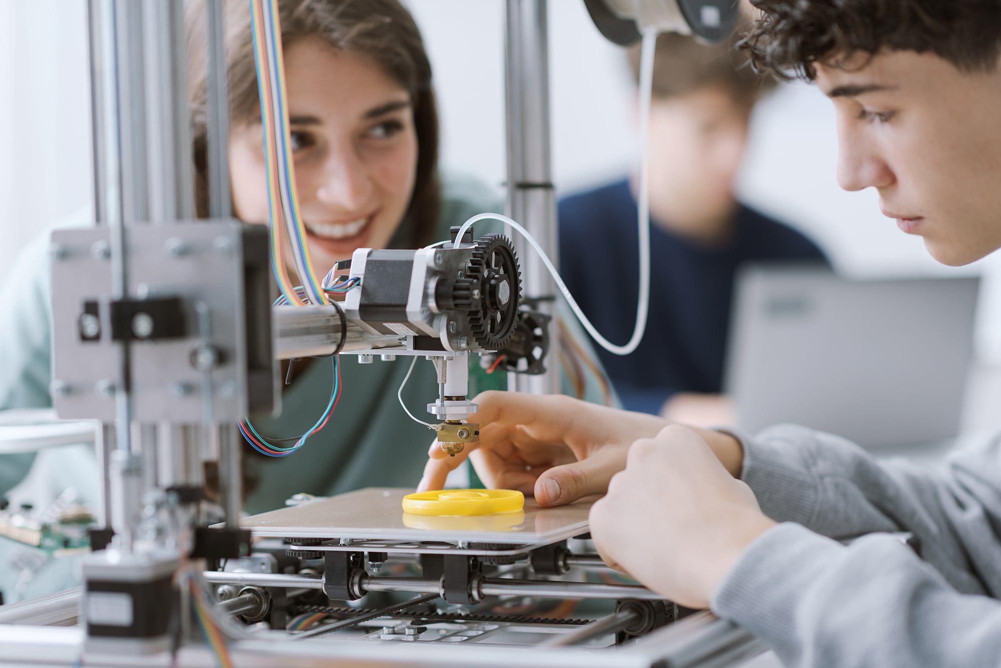 Students using 3D printer.
